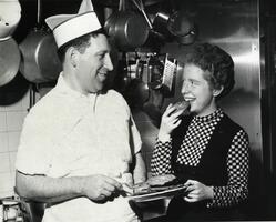 Student with Alfred Parker (head of Dining Services) sampling latkes (potato pancakes) for Hanukkah