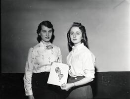 Students of first graduating class Anne Rosenbaum and Ruth Solomon with drawing of SCW class ring