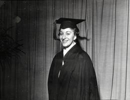 Member of first graduating class Marilyn Bell in cap, gown