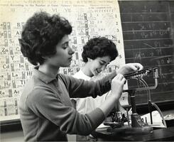 Two students in laboratory working with scale