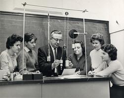Students with Physics Professor Henry Lisman demonstrating with weights