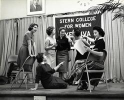 Students on stage rehearsing a performance