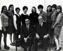 Group of students posing with Dean David Mirsky and unidentified man