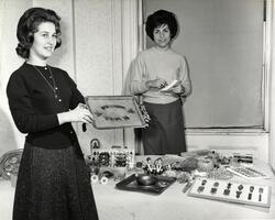 Students displaying Judaica items at gift shop opening