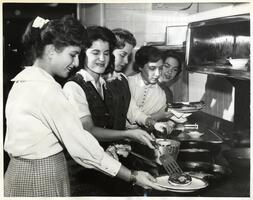 Students cooking latkes (potato pancakes) for Hanukkah