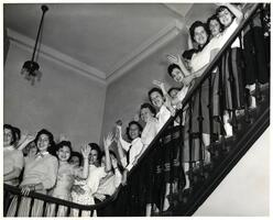 Students of first entering class waving on stairs