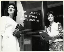 Two students at entrance to SCW building