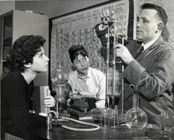 Two students with Professor of Chemistry Jacob Rabinowitz in lab
