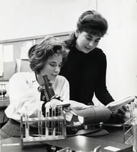 Two students using microscope