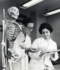 Student with instructor examining anatomy model