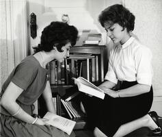 Two students examining books