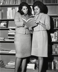 Two students examining SCW catalog