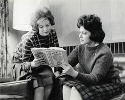 Two students in lounge reading