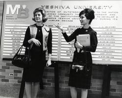 Two students at Master Builders wall on uptown campus