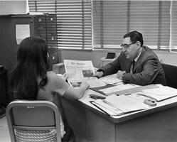 Student discussing The Observer student newspaper with Dean David Mirsky