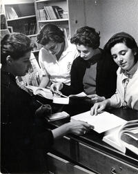 Staff member assisting students