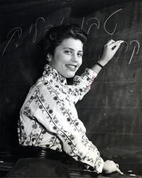 Student Sura (Schreiber) Katz, of first graduating class, at blackboard